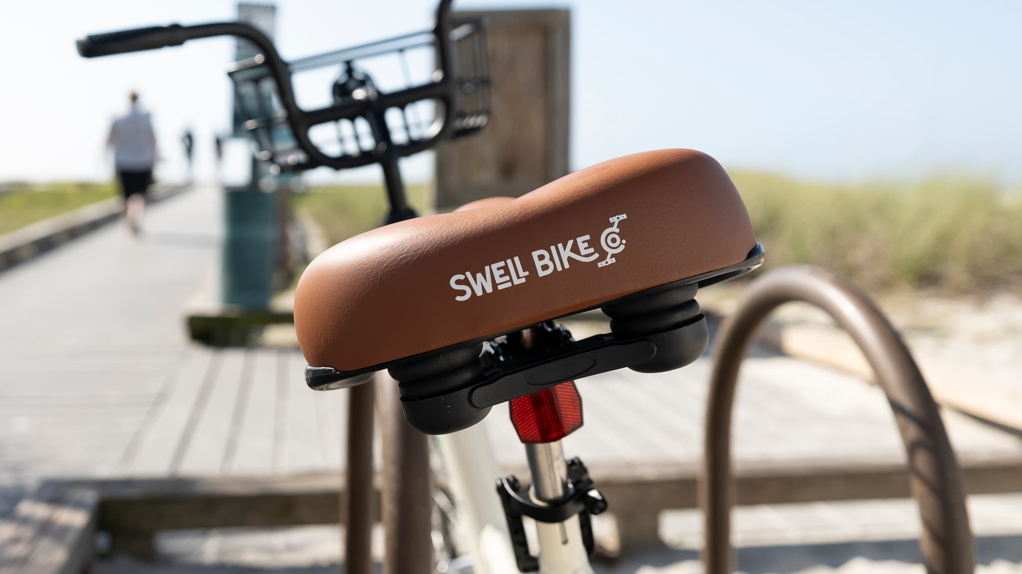 The Swell Bike logo on a brown saddle