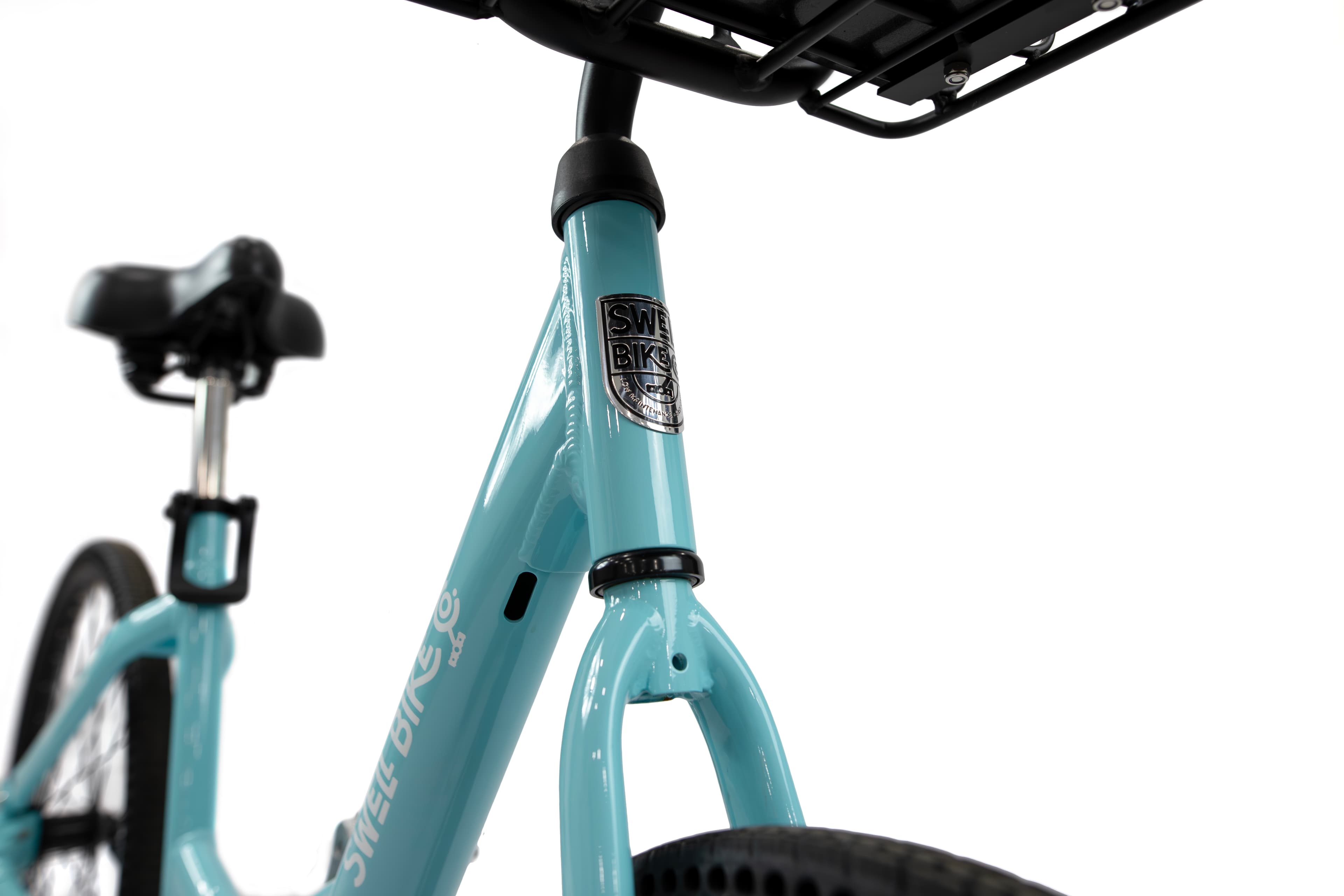 Close-up of a light-teal Swell frame and its head badge